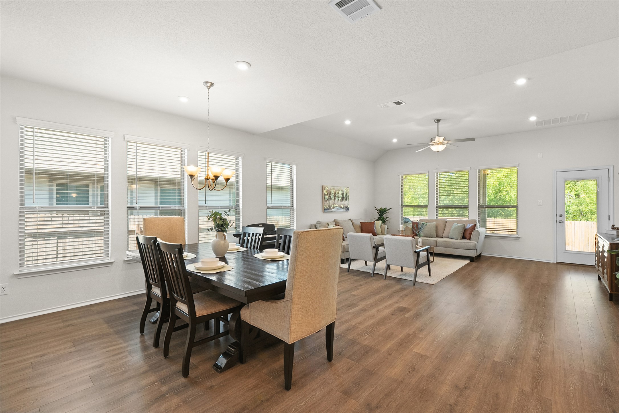 211 Brookside Street Hutto, TX 78634 - Photo 14 of 40 Dining space with a chandelier, dark wood-style floors, recessed lighting, ceiling fan, and vaulted ceiling