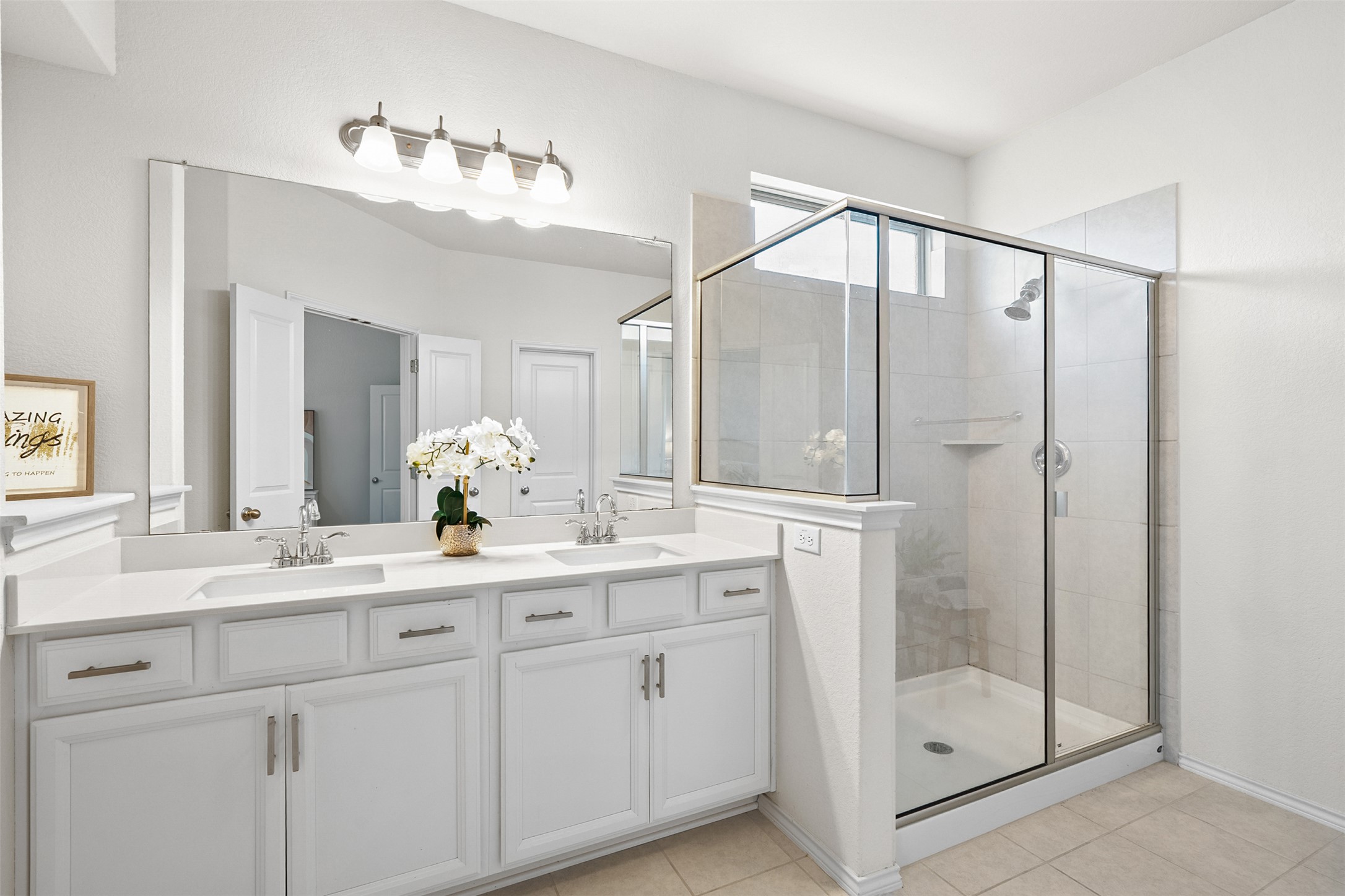 211 Brookside Street Hutto, TX 78634 - Photo 18 of 40 Full bathroom with a shower stall, double vanity, and light tile patterned floors