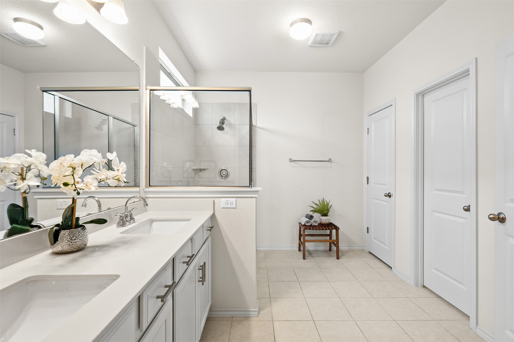 211 Brookside Street Hutto, TX 78634 - Photo 19 of 40 Bathroom with a stall shower, double vanity, and light tile patterned floors
