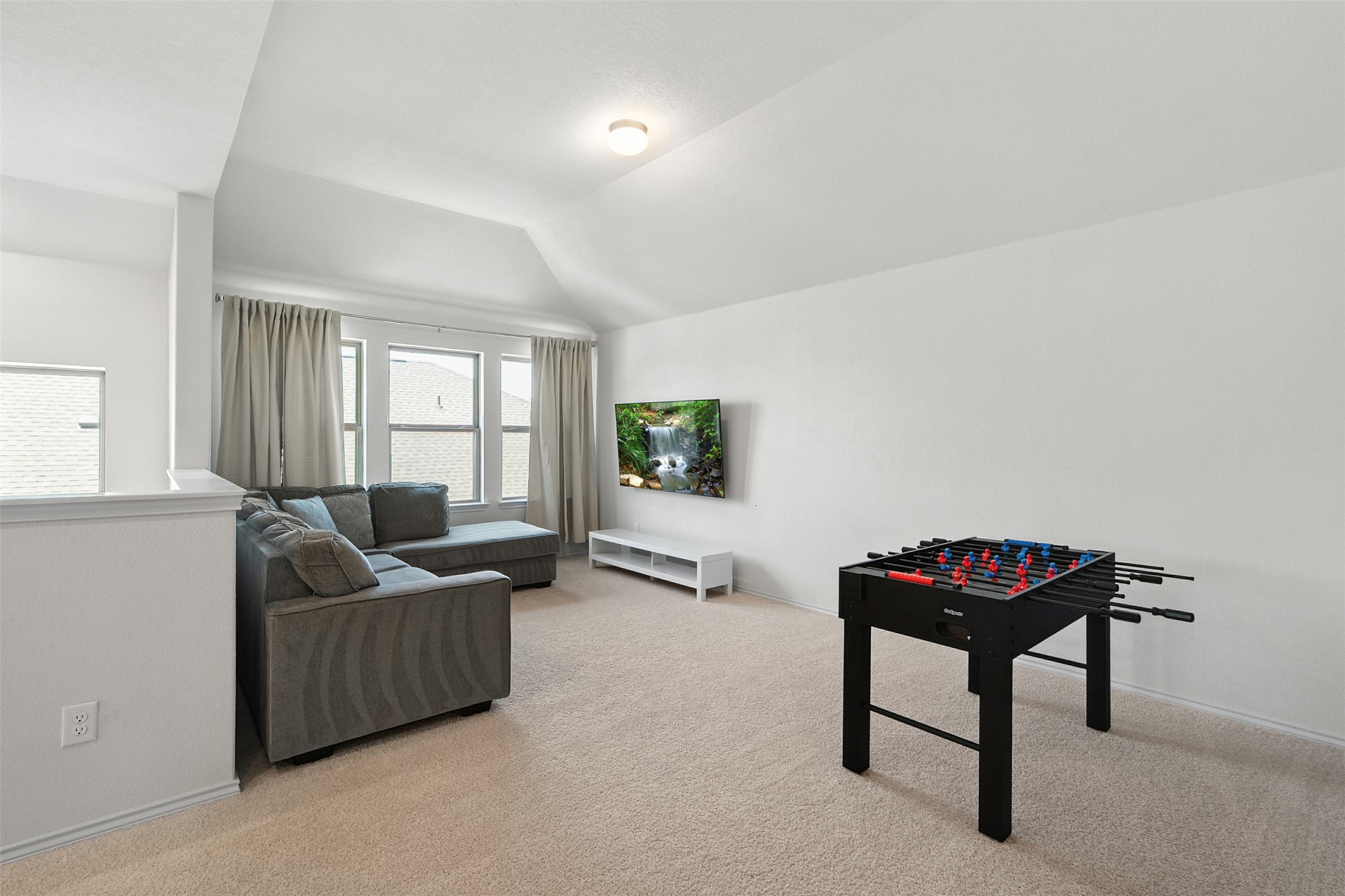 211 Brookside Street Hutto, TX 78634 - Photo 26 of 40 Game room featuring light carpet and lofted ceiling