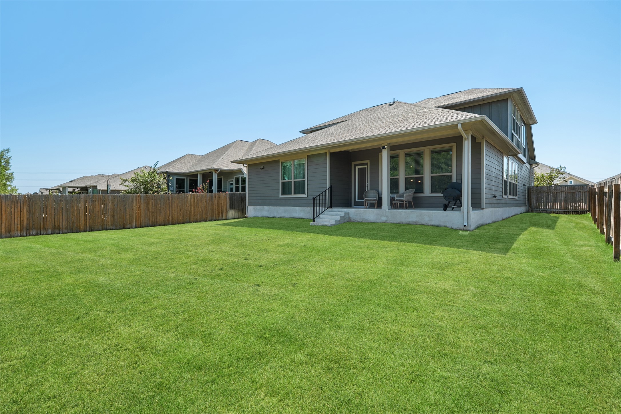 211 Brookside Street Hutto, TX 78634 - Photo 31 of 40 Rear view of property featuring a fenced backyard, a patio area, and a shingled roof