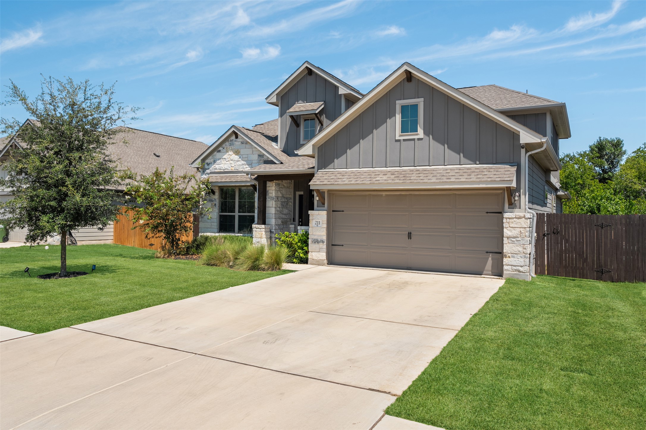 211 Brookside Street Hutto, TX 78634 - Photo 7 of 40 Craftsman-style house with stone siding, board and batten siding, and roof with shingles