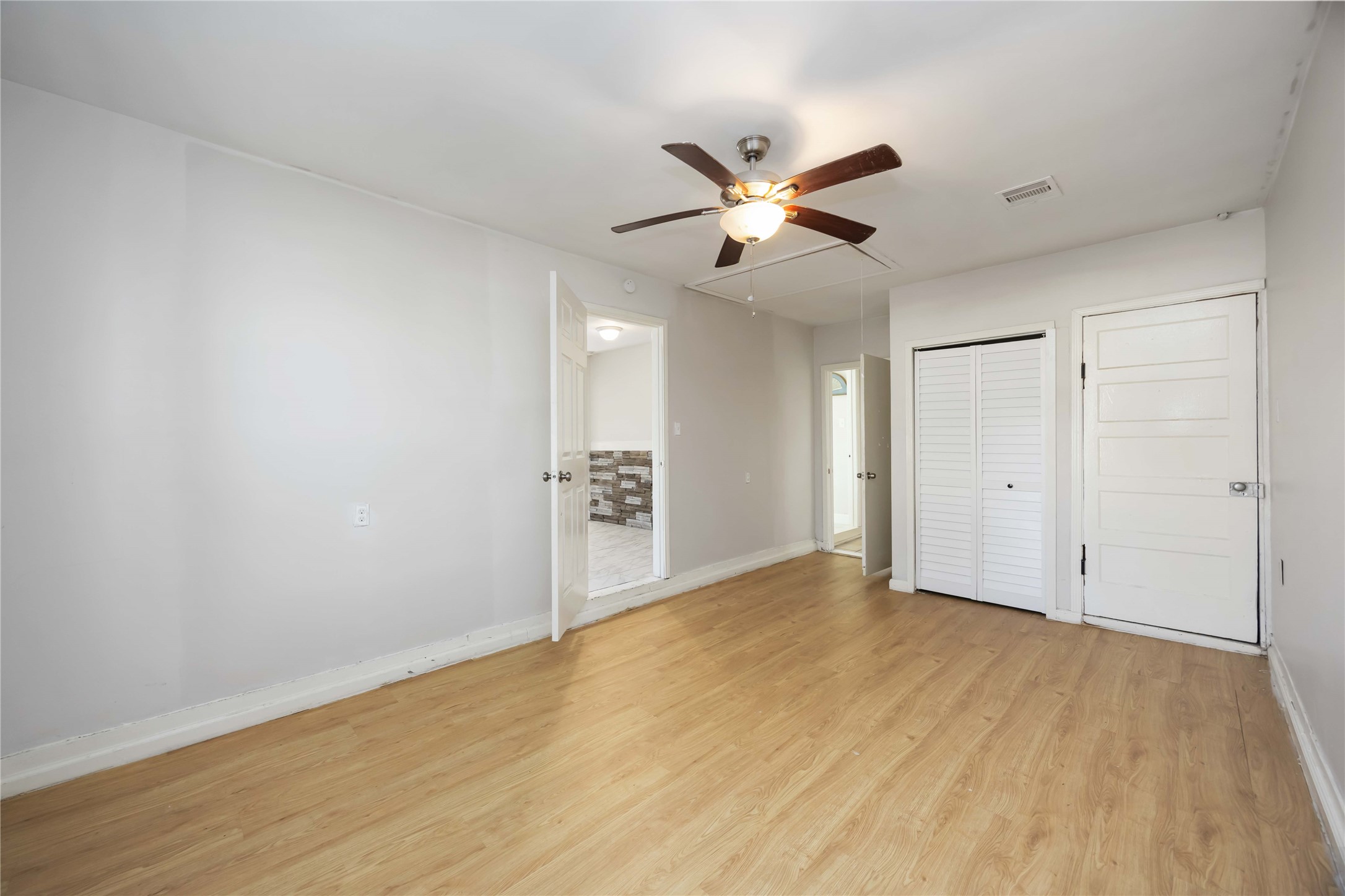5934 Belcrest Street Houston, TX 77033 - Photo 12 of 17 a view of empty room with wooden floor and window