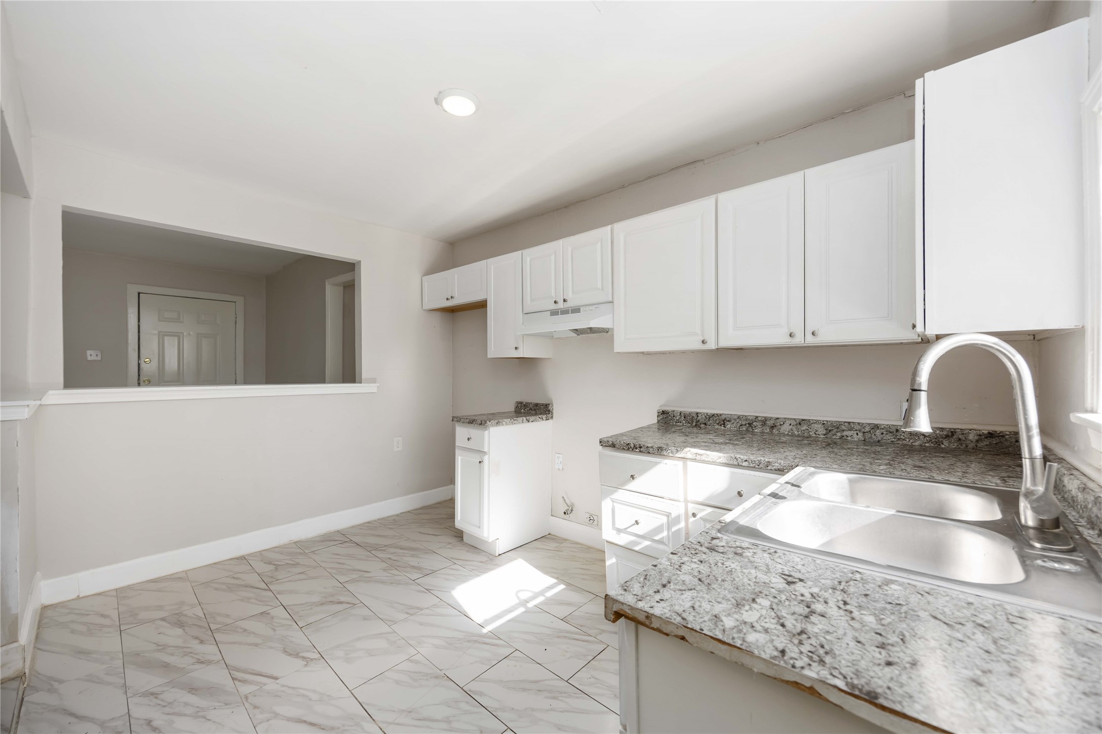 5934 Belcrest Street Houston, TX 77033 - Photo 6 of 17 a kitchen with a sink and cabinets