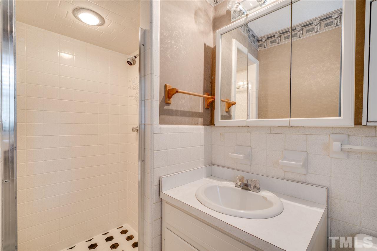 3307 Baugh Street Raleigh, NC 27604 - Photo 14 of 27 a bathroom with a sink and a mirror
