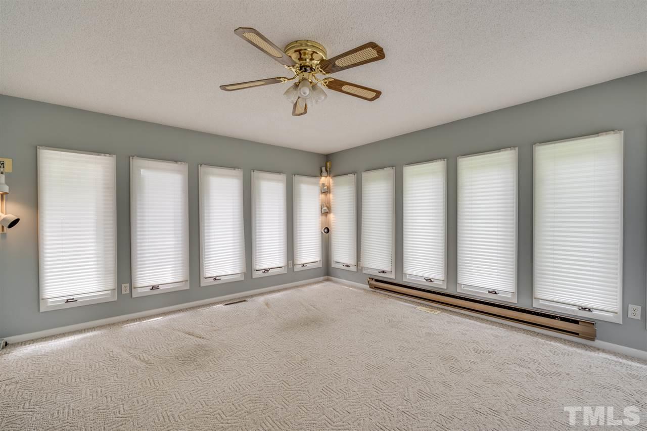 3307 Baugh Street Raleigh, NC 27604 - Photo 9 of 27 an empty room with chandelier fan and windows