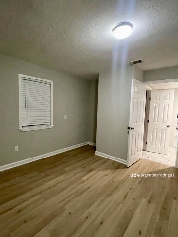 26342 Welch Road Splendora, TX 77372 - Photo 11 of 15 an empty room with wooden floor and windows