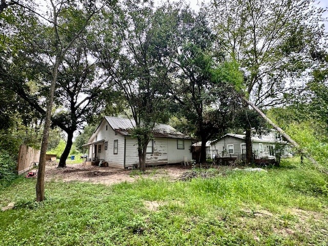 26342 Welch Road Splendora, TX 77372 - Photo 15 of 15 a view of a house with backyard and a tree