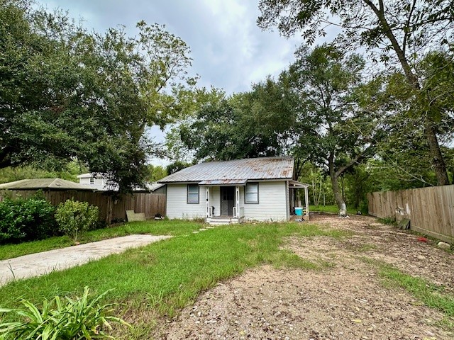 26342 Welch Road Splendora, TX 77372 - Photo 2 of 15 a front view of a house with a yard and trees