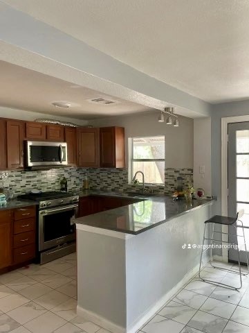 26342 Welch Road Splendora, TX 77372 - Photo 3 of 15 a kitchen with stainless steel appliances granite countertop a stove and a sink