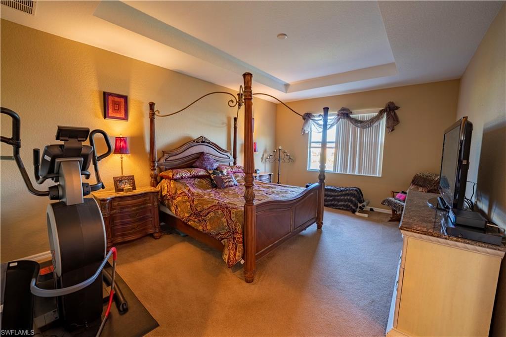 20007 Larino Loop Estero, FL 33928 - Photo 18 of 27 a bedroom with bed and wooden floor