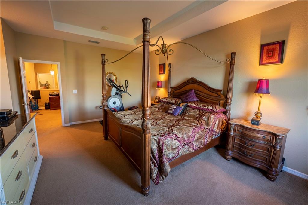 20007 Larino Loop Estero, FL 33928 - Photo 19 of 27 a bedroom with bed and wooden floor