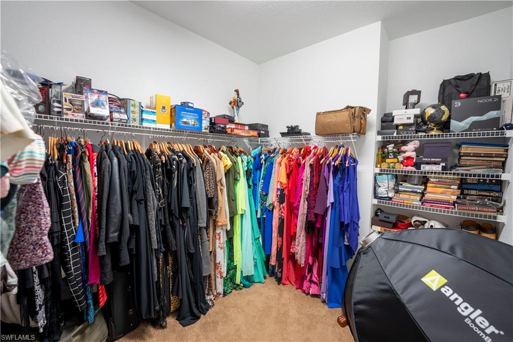 20007 Larino Loop Estero, FL 33928 - Photo 20 of 27 a view of walk in closet with clothes and shoes