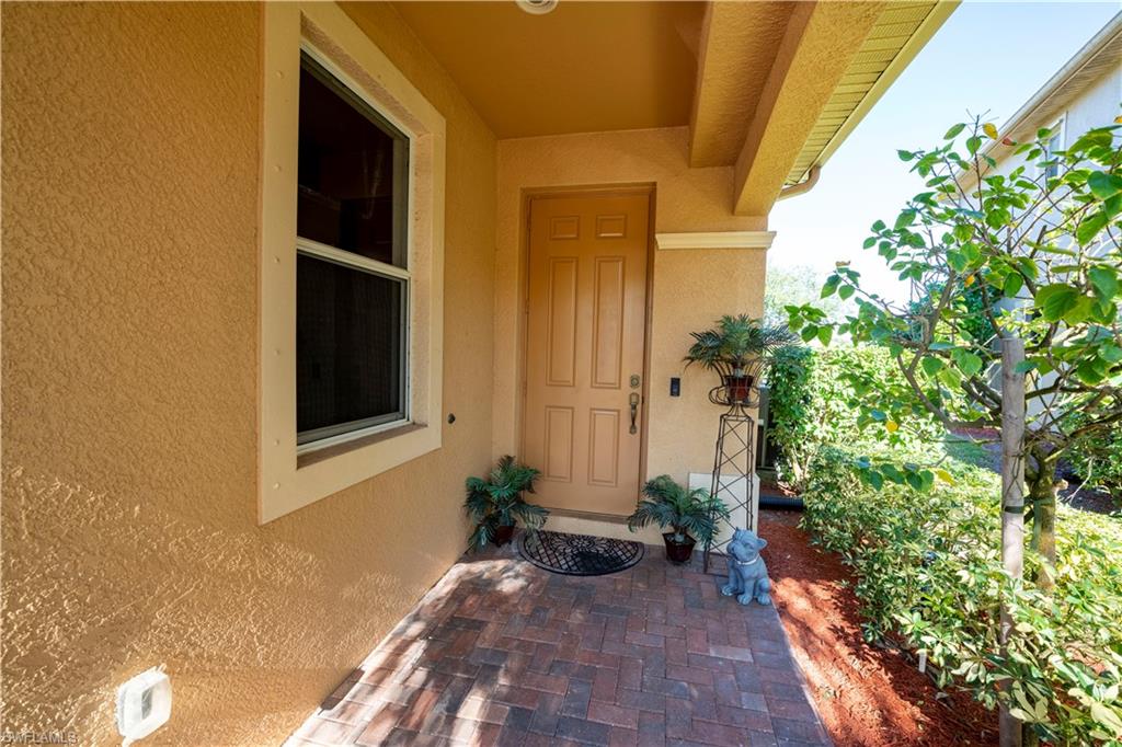20007 Larino Loop Estero, FL 33928 - Photo 2 of 27 a front view of a house with a yard
