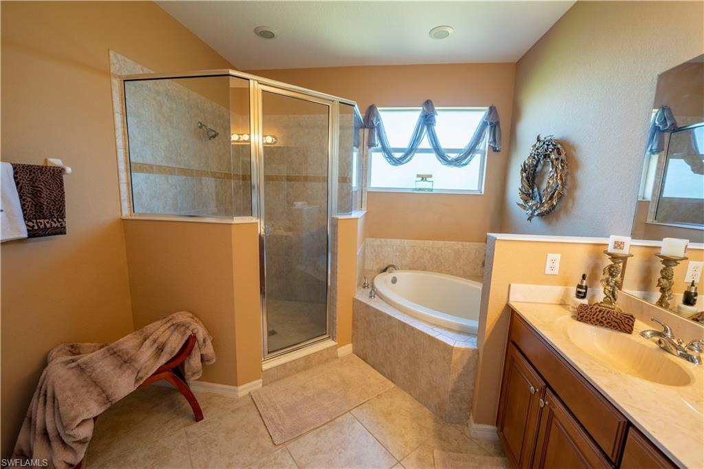 20007 Larino Loop Estero, FL 33928 - Photo 21 of 27 a bathroom with a tub sink and mirror