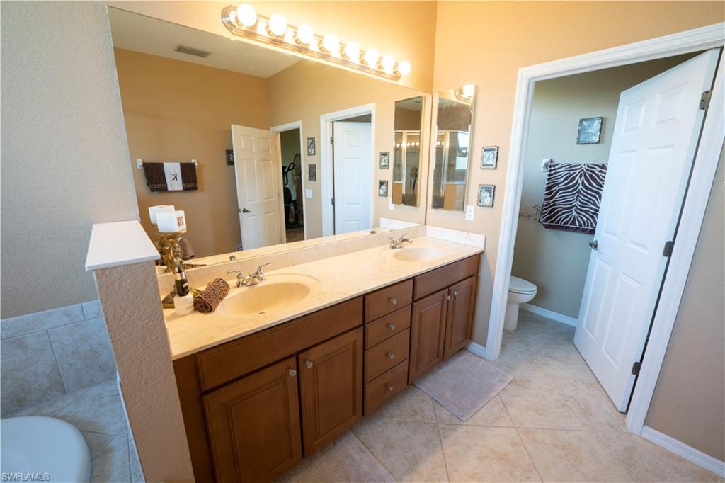 20007 Larino Loop Estero, FL 33928 - Photo 22 of 27 a bathroom with a double vanity sink mirror and toilet