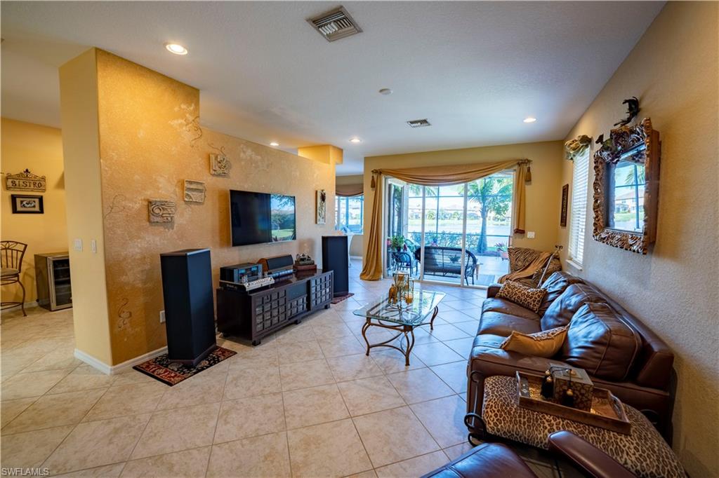 20007 Larino Loop Estero, FL 33928 - Photo 4 of 27 a living room with furniture and a flat screen tv