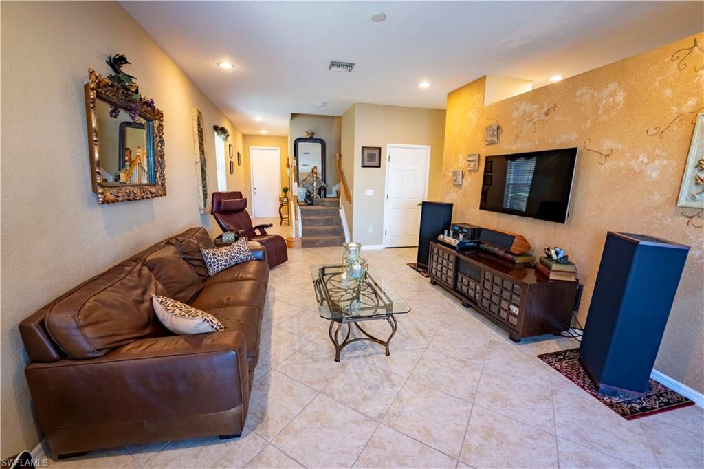 20007 Larino Loop Estero, FL 33928 - Photo 5 of 27 a living room with furniture and a flat screen tv