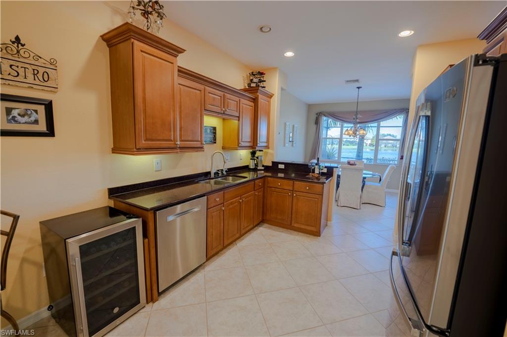 20007 Larino Loop Estero, FL 33928 - Photo 9 of 27 a kitchen with a sink appliances and cabinets