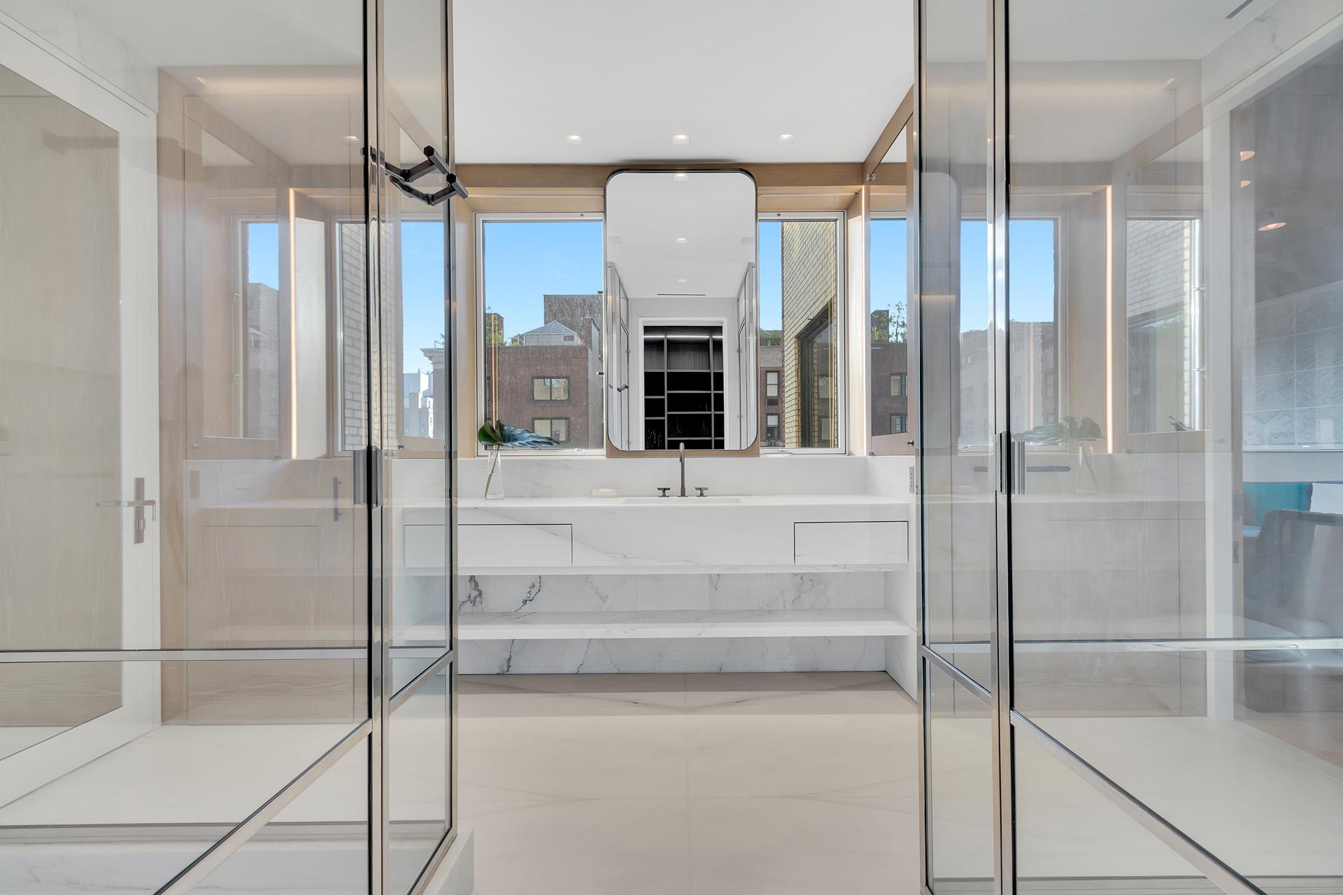 730 Park Avenue, Unit 10C/11C Manhattan, NY 10021 - Photo 14 of 27 a view of a hallway with a chandelier and fireplace