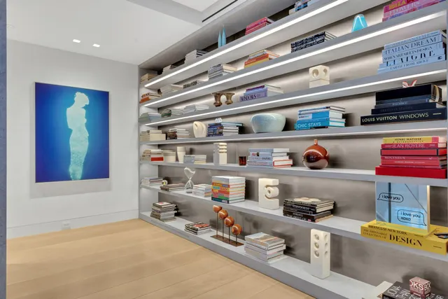 a view of a living room with a large window and chandelier