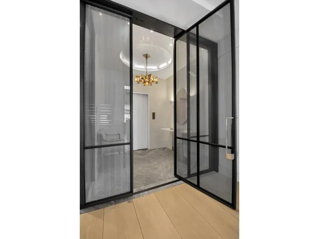 a living room with fireplace furniture and a large window