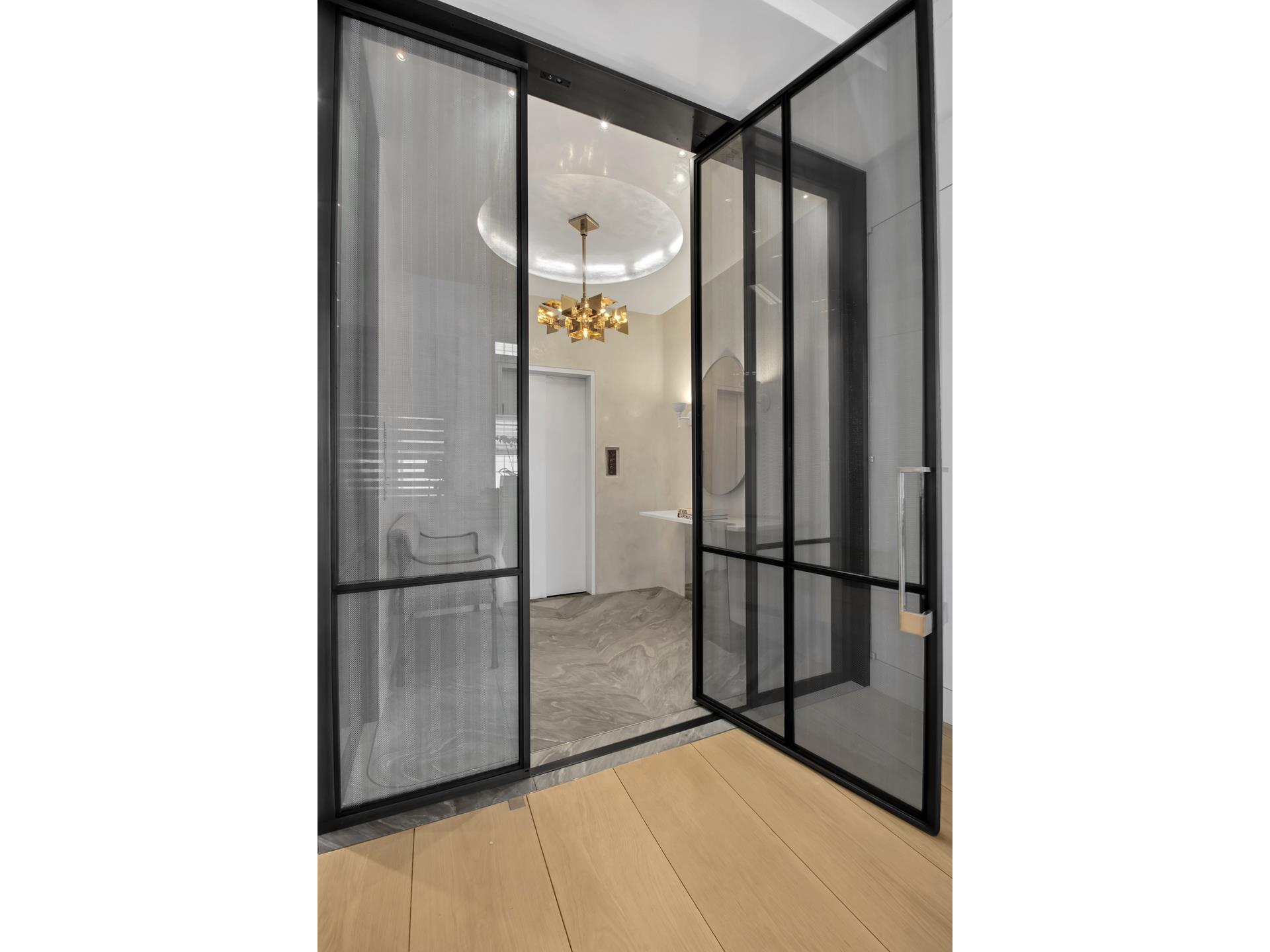 730 Park Avenue, Unit 10C/11C Manhattan, NY 10021 - Photo 5 of 27 a view of a refrigerator in kitchen and wooden floor