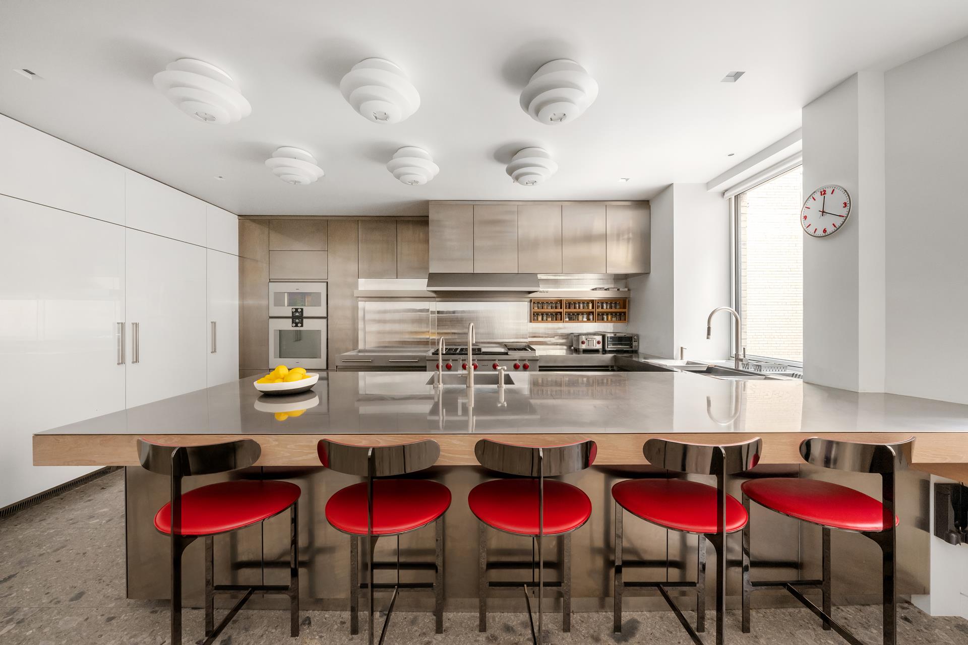 730 Park Avenue, Unit 10C/11C Manhattan, NY 10021 - Photo 6 of 27 a view of kitchen with stainless steel appliances kitchen island granite countertop cabinets and stove top oven