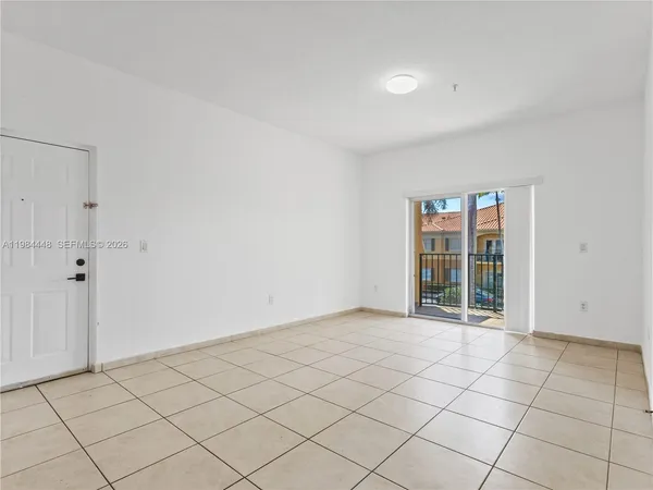 a view of a refrigerator in kitchen and white cabinets