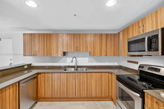 a view of kitchen island with cabinets and wooden floor