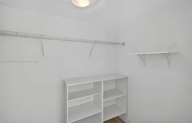 a living room with a large window and a flat screen tv