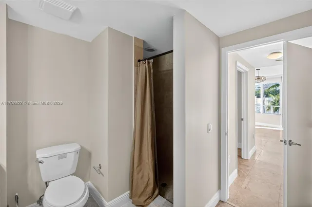 a living room with furniture a flat screen tv and floor to ceiling window