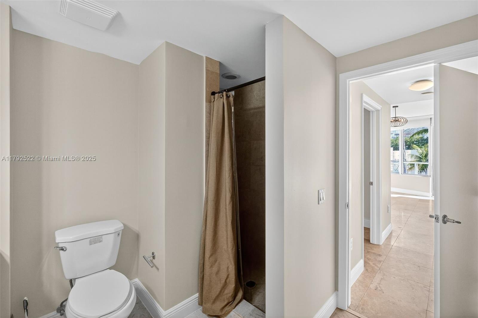 6305 Indian Creek Drive, Unit 3F Miami Beach, FL 33141 - Photo 36 of 60 a white toilet sitting next to a bathroom sink