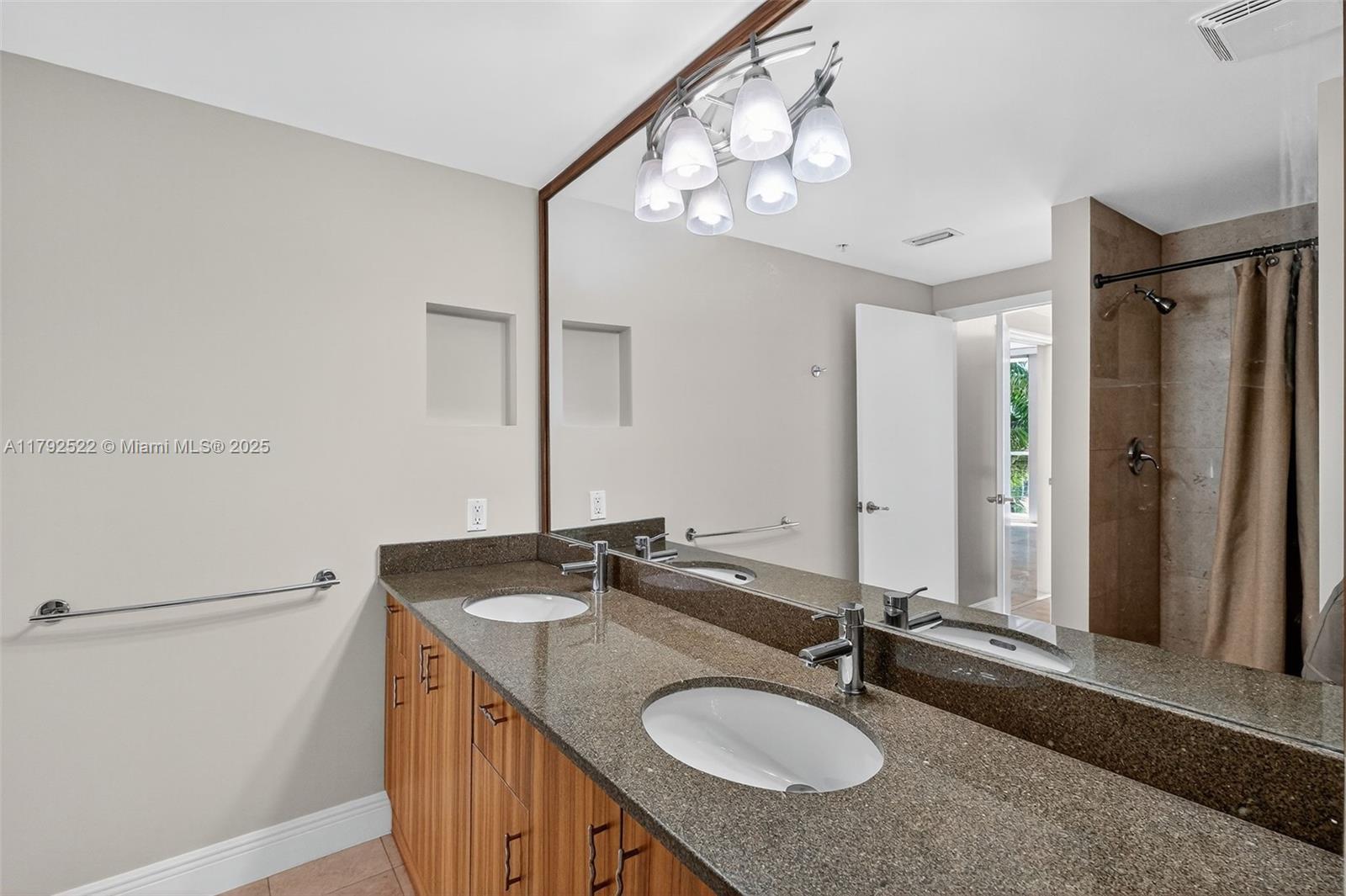 6305 Indian Creek Drive, Unit 3F Miami Beach, FL 33141 - Photo 37 of 60 a bathroom with a granite countertop sink and a mirror