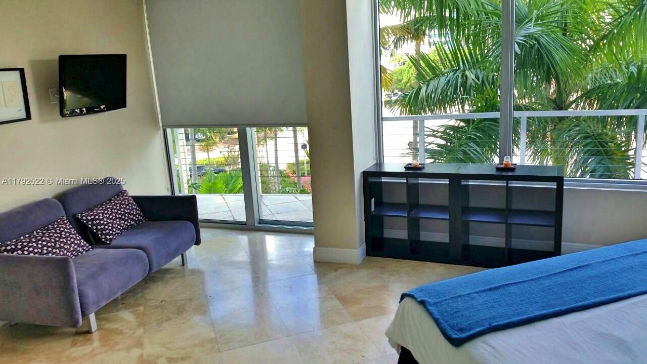 6305 Indian Creek Drive, Unit 3F Miami Beach, FL 33141 - Photo 42 of 60 a living room with furniture a flat screen tv and floor to ceiling window