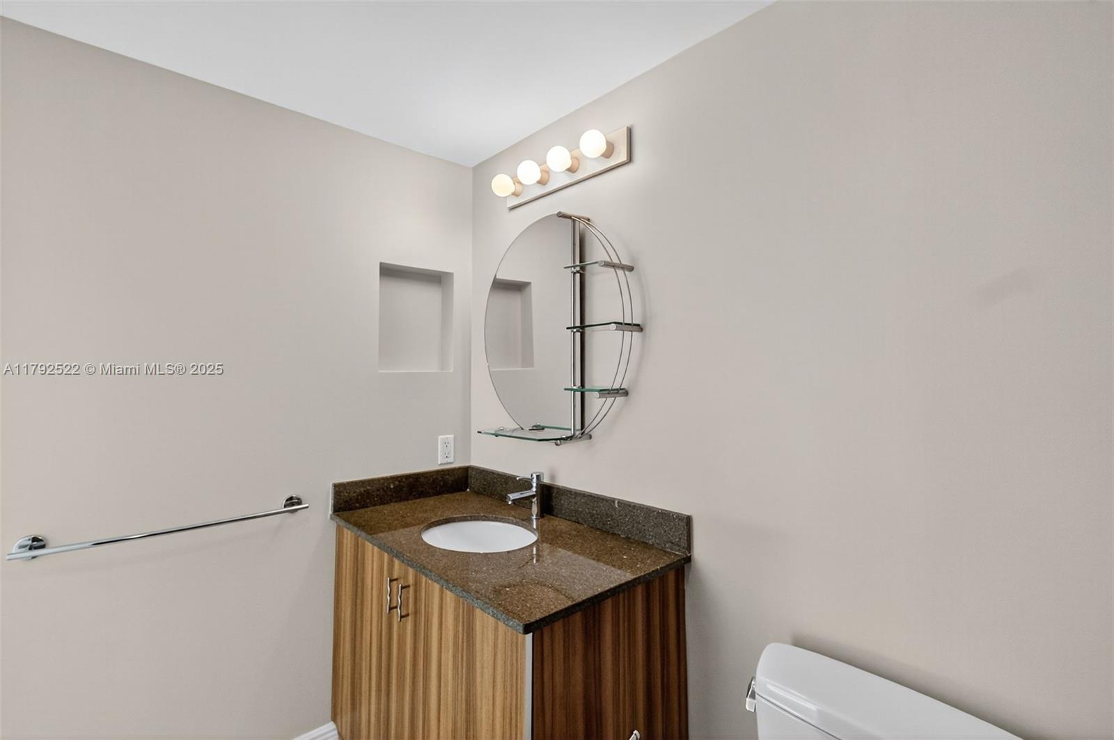 6305 Indian Creek Drive, Unit 3F Miami Beach, FL 33141 - Photo 46 of 60 a bathroom with a sink and a mirror