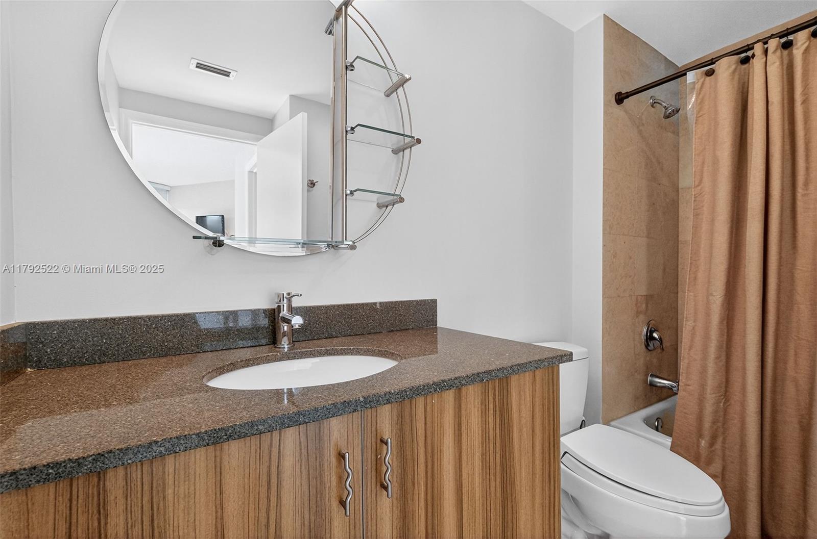 6305 Indian Creek Drive, Unit 3F Miami Beach, FL 33141 - Photo 47 of 60 a bathroom with a sink a toilet and a mirror