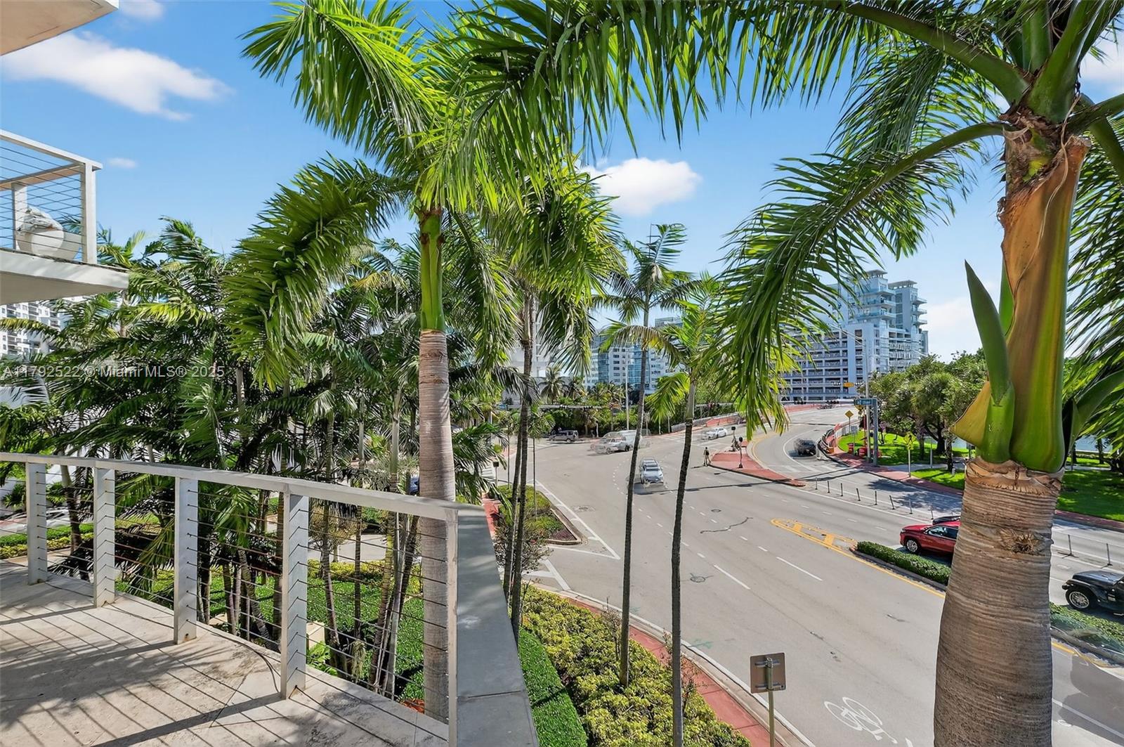 6305 Indian Creek Drive, Unit 3F Miami Beach, FL 33141 - Photo 50 of 60 a view of a palm tree with wooden fence
