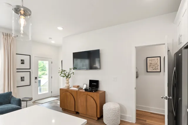 a living room with furniture a flat screen tv and a fireplace