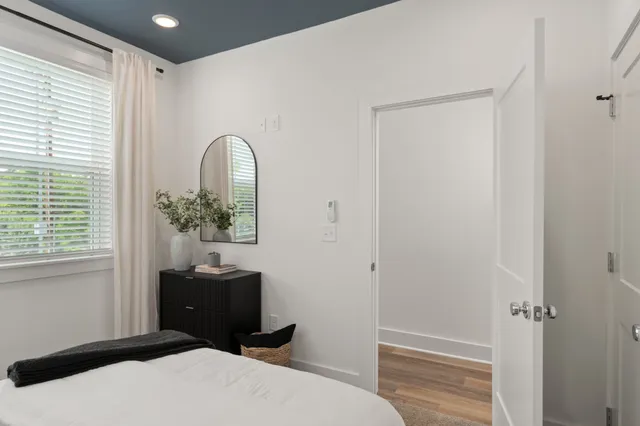 a bedroom with a bed and a potted plant