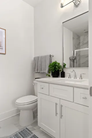 a bathroom with a sink a toilet and mirror