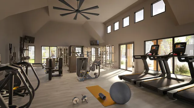 a room with gym equipment and windows