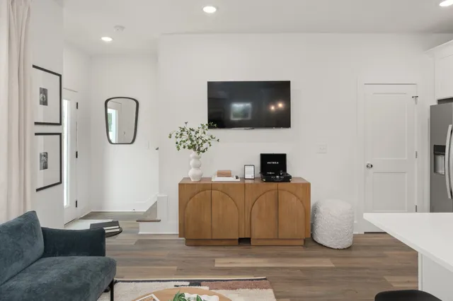 a living room with furniture and a flat screen tv