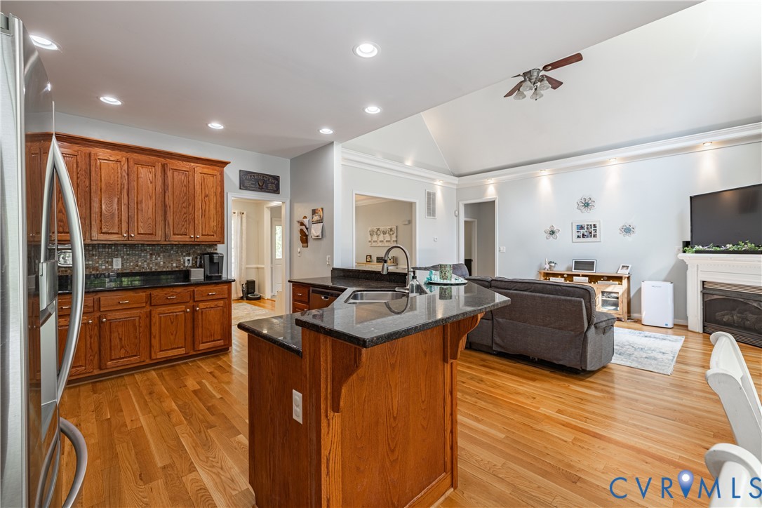 4789 Tatum Road Disputanta, VA 23842 - Photo 15 of 46 a large kitchen with stainless steel appliances granite countertop a stove and a wooden floors