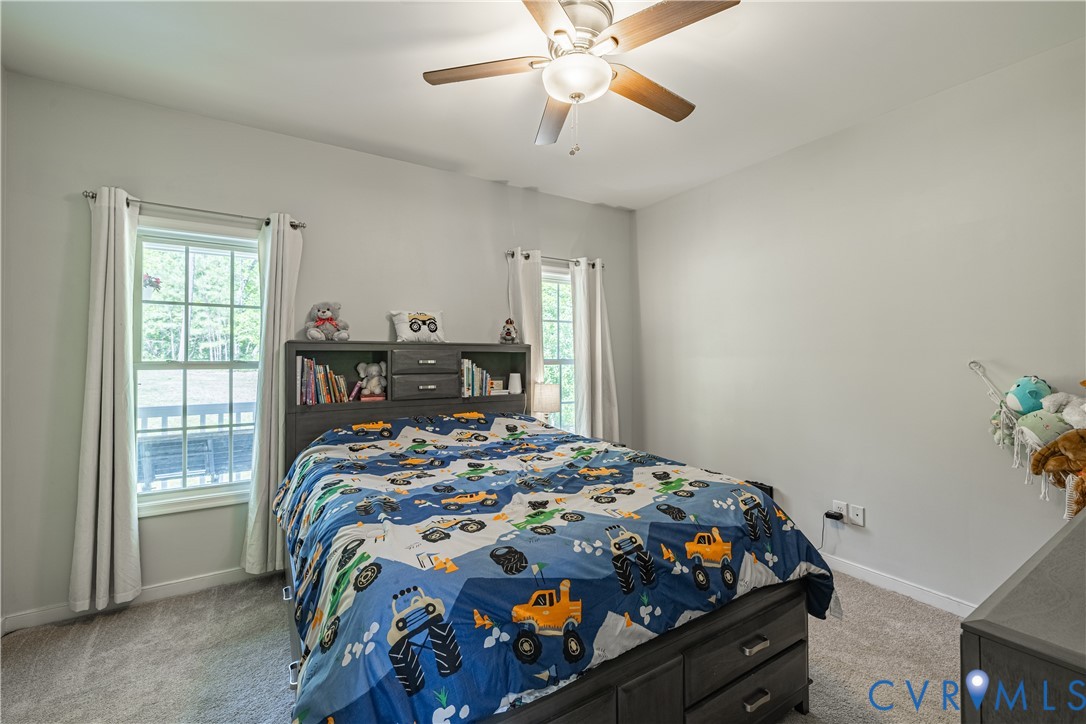 4789 Tatum Road Disputanta, VA 23842 - Photo 18 of 46 a bedroom with bed and windows