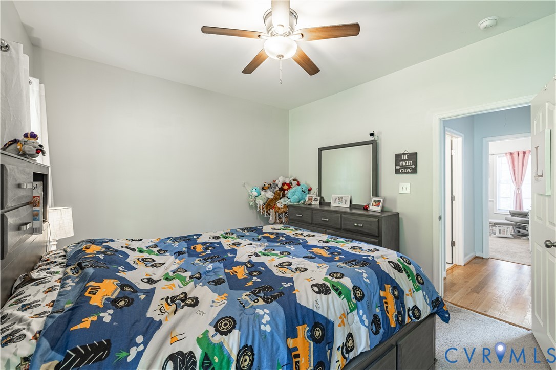4789 Tatum Road Disputanta, VA 23842 - Photo 19 of 46 a bedroom with a bed and a chandelier