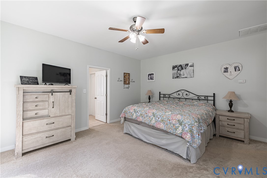 4789 Tatum Road Disputanta, VA 23842 - Photo 23 of 46 a bedroom with a bed and a flat screen tv