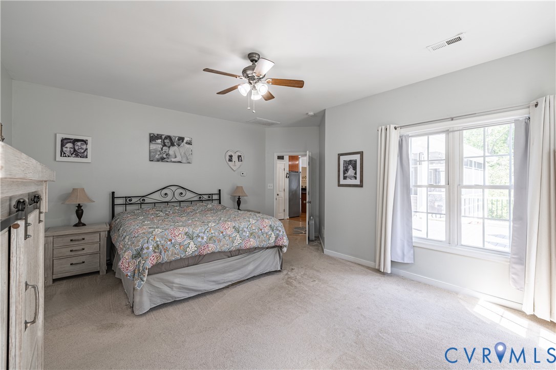 4789 Tatum Road Disputanta, VA 23842 - Photo 24 of 46 a bedroom with a bed and a chandelier