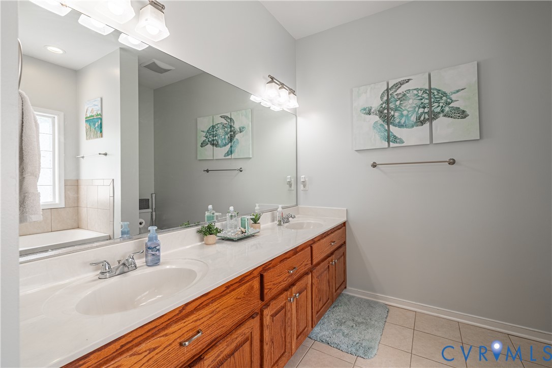 4789 Tatum Road Disputanta, VA 23842 - Photo 25 of 46 a bathroom with a double vanity sink and a mirror