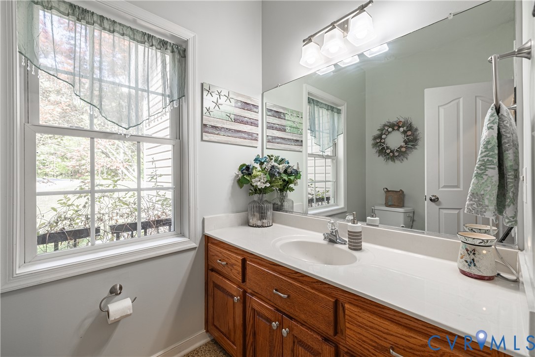 4789 Tatum Road Disputanta, VA 23842 - Photo 30 of 46 a bathroom with a sink a vanity and a mirror
